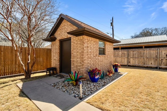 view of outbuilding featuring a fenced backyard and an outbuilding
