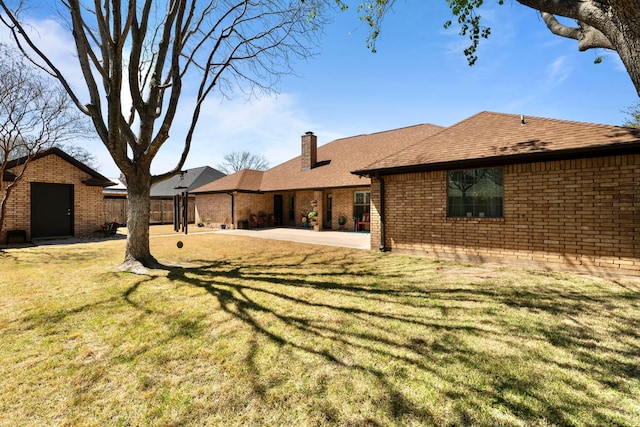 view of yard featuring an outdoor structure, fence, and a patio