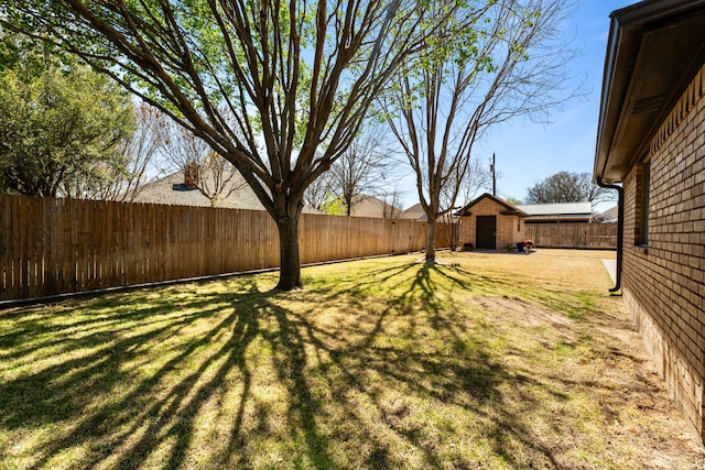 view of yard with an outdoor structure and a fenced backyard