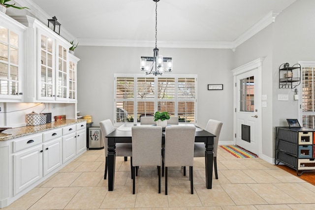 dining room with baseboards, a notable chandelier, ornamental molding, and light tile patterned floors