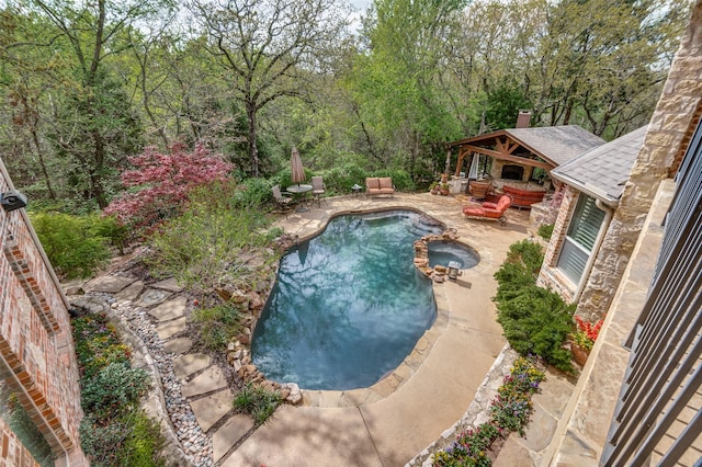 view of swimming pool featuring a gazebo, a patio, and a pool with connected hot tub