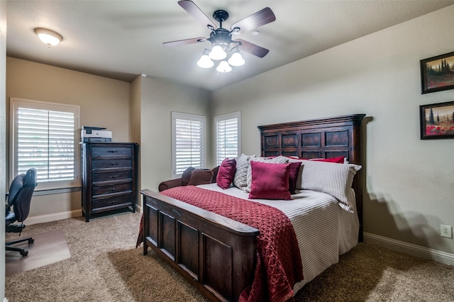 carpeted bedroom with baseboards and a ceiling fan