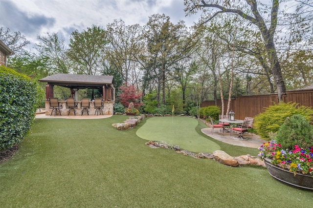 view of yard featuring a gazebo, outdoor dry bar, a patio, and fence