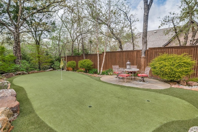 view of yard featuring fence and a patio
