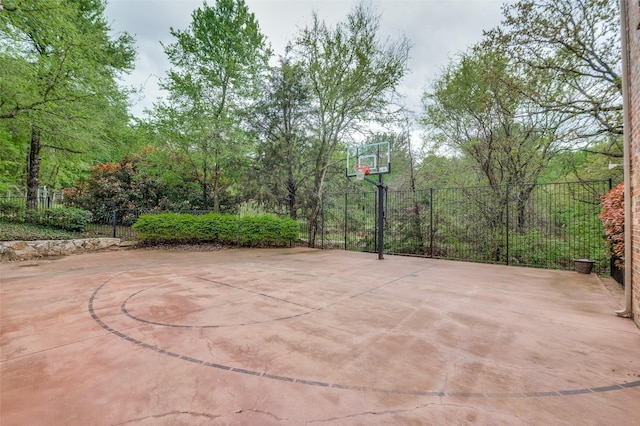 view of basketball court with community basketball court and fence