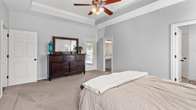 carpeted bedroom with a raised ceiling, ornamental molding, baseboards, and ceiling fan