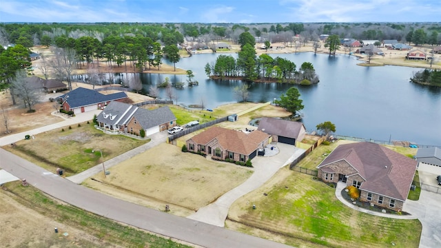 drone / aerial view featuring a residential view and a water view