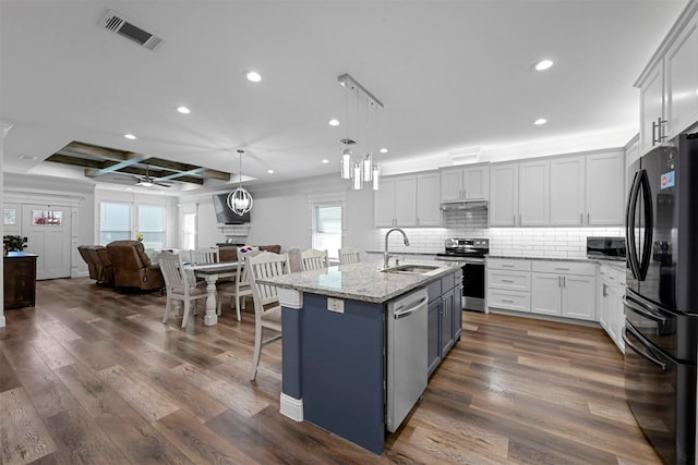 3025 S College Blvd, Denison, TX 75020 - kitchen featuring open floor plan, dark wood finished floors, a sink, visible vents, and appliances with stainless steel finishes