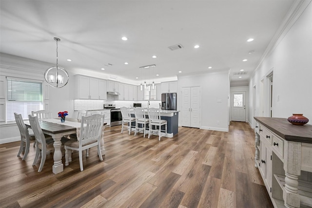 3025 S College Blvd, Denison, TX 75020 - dining room with visible vents, recessed lighting, a notable chandelier, and wood finished floors
