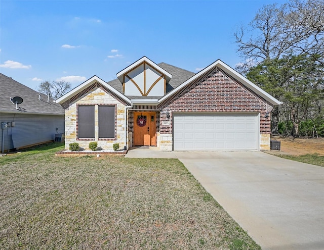 3025 S College Blvd, Denison, TX 75020 - view of front of property featuring concrete driveway, an attached garage, stone siding, a front yard, and brick siding
