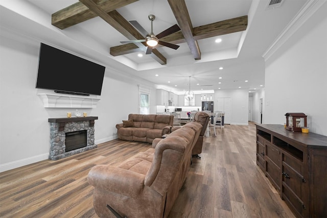3025 S College Blvd, Denison, TX 75020 - living room featuring baseboards, wood finished floors, a ceiling fan, a stone fireplace, and coffered ceiling