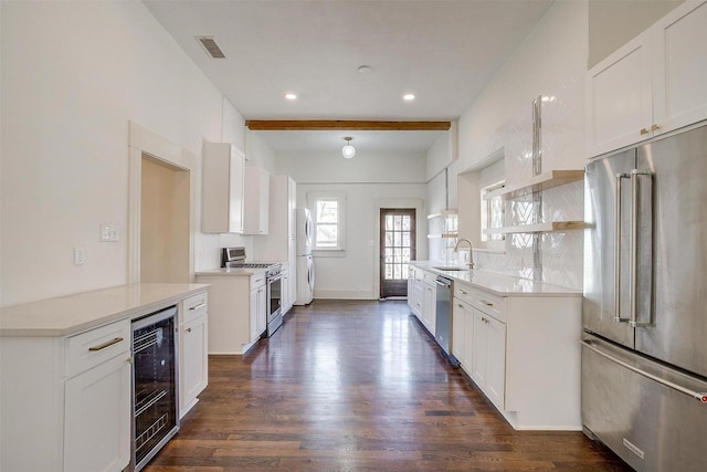 kitchen featuring wine cooler, a sink, high quality appliances, dark wood-style floors, and visible vents