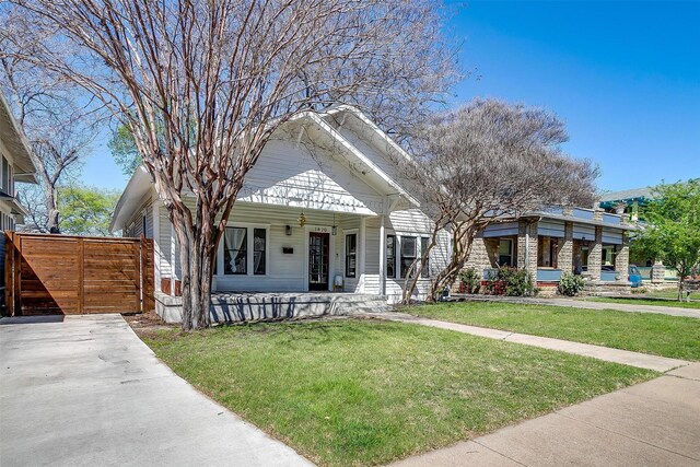 bungalow-style house featuring a front lawn and covered porch