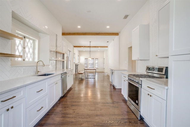 kitchen featuring stainless steel appliances, dark wood finished floors, white cabinetry, a sink, and open shelves