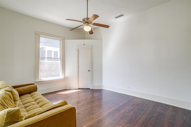unfurnished room featuring baseboards, dark wood-style flooring, visible vents, and a ceiling fan