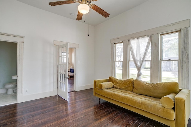 living area with plenty of natural light, baseboards, wood finished floors, and ceiling fan