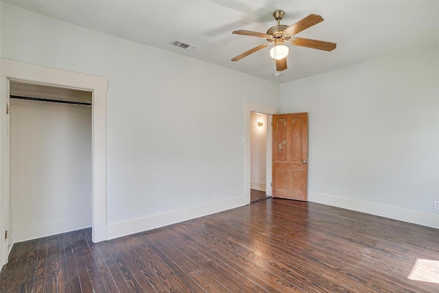 unfurnished bedroom featuring baseboards, visible vents, and wood finished floors