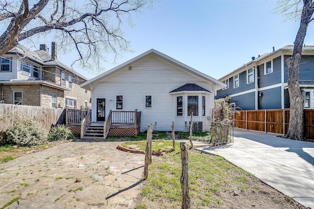 back of property featuring fence and a wooden deck