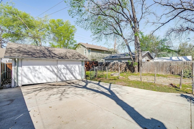 detached garage featuring fence