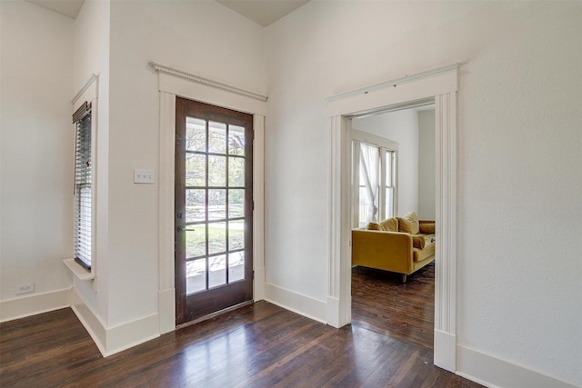 entrance foyer featuring baseboards, dark wood-style flooring, and a healthy amount of sunlight