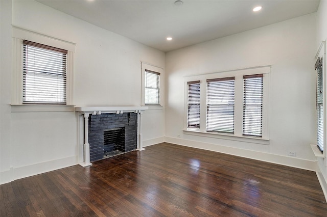 unfurnished living room featuring baseboards, a fireplace, recessed lighting, and wood-type flooring