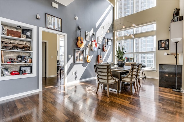 2323 N Houston St Unit 710, Dallas, TX 75219 - dining room with hardwood / wood-style floors, a high ceiling, healthy amount of natural light, and baseboards