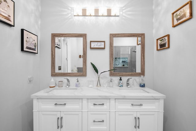 full bath featuring double vanity, a sink, and a shower with shower door