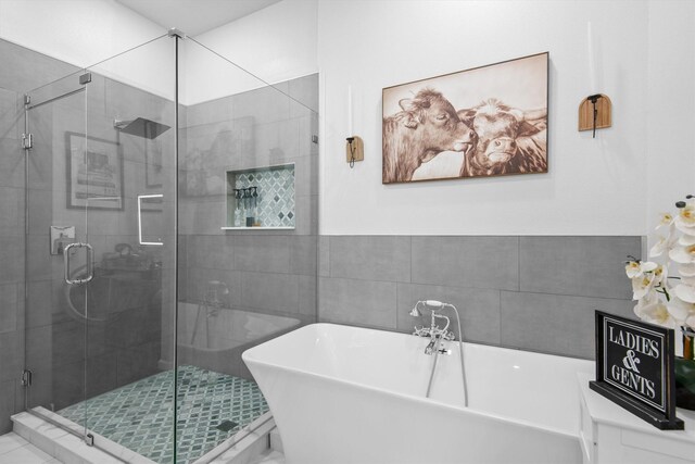 bathroom with a freestanding tub and a stall shower