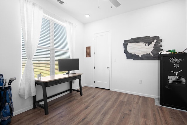 office featuring a ceiling fan, visible vents, baseboards, and wood finished floors