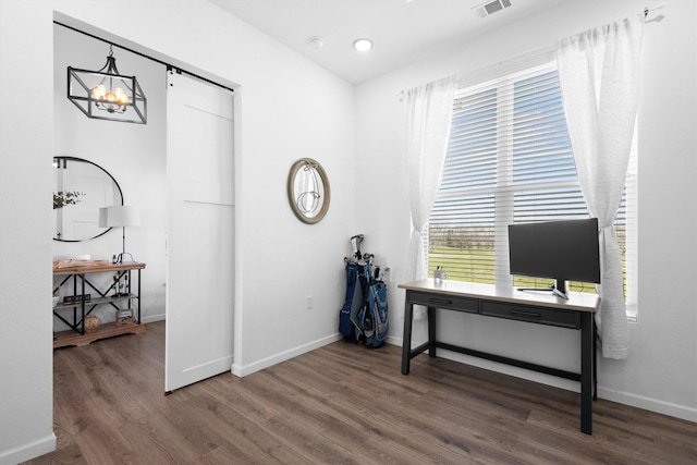 office featuring baseboards, visible vents, wood finished floors, and a chandelier