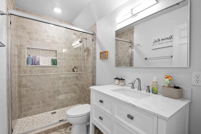 full bath with a shower stall, toilet, and vanity