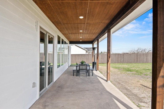 view of patio with outdoor dining area and fence