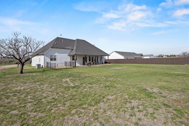 view of yard featuring central AC unit, fence, and a patio
