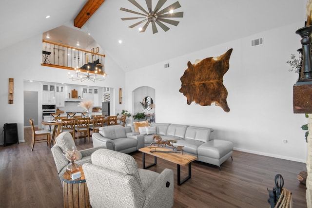 living room featuring dark wood finished floors, beamed ceiling, visible vents, and an inviting chandelier