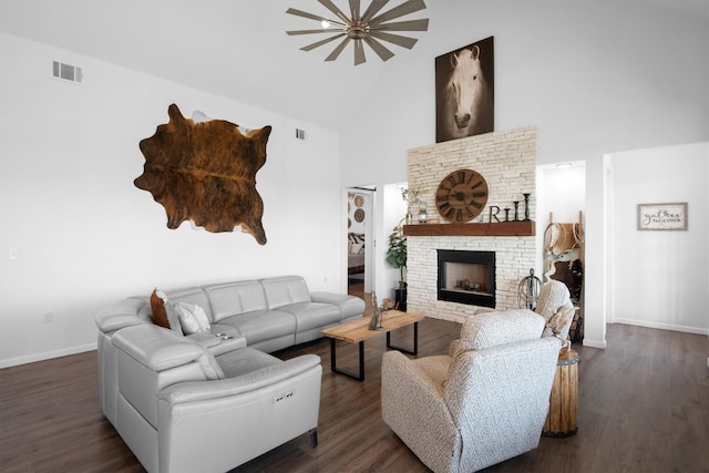living area with high vaulted ceiling, visible vents, baseboards, a fireplace, and dark wood-style floors