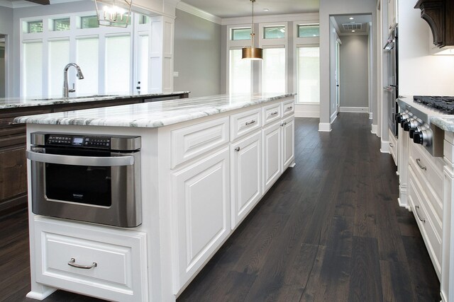 7603 Timber Trl, Tyler, TX 75703 - kitchen with stainless steel appliances, a sink, baseboards, white cabinetry, and ornamental molding