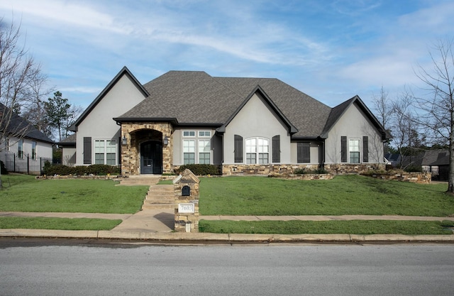 7603 Timber Trl, Tyler, TX 75703 - french country style house featuring stucco siding, stone siding, and a front lawn