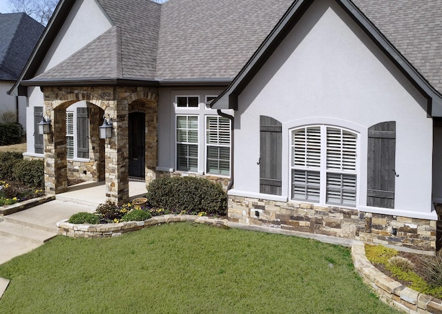 7603 Timber Trl, Tyler, TX 75703 - view of front of property with stone siding, roof with shingles, stucco siding, and a front lawn
