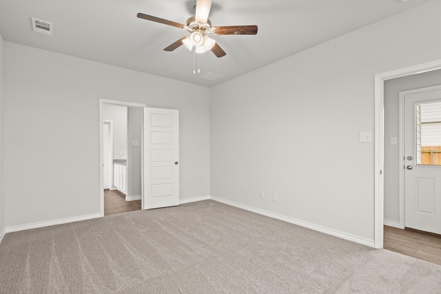 unfurnished bedroom with baseboards, visible vents, carpet, and a ceiling fan