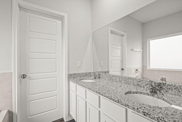 full bath with double vanity and a sink