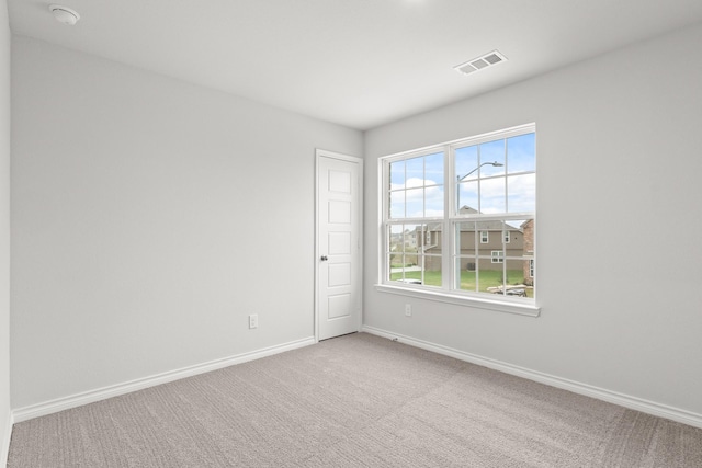 carpeted empty room with baseboards and visible vents