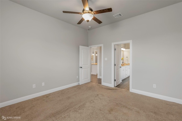 918 Hackberry Dr, Bossier City, LA 71111 - unfurnished bedroom featuring carpet, baseboards, ensuite bath, and a ceiling fan