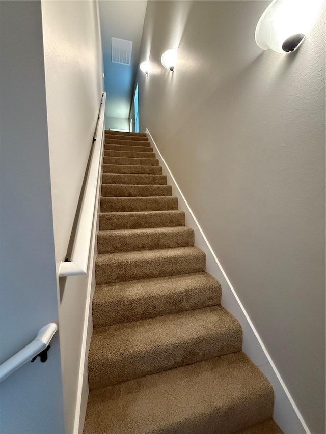 staircase featuring visible vents