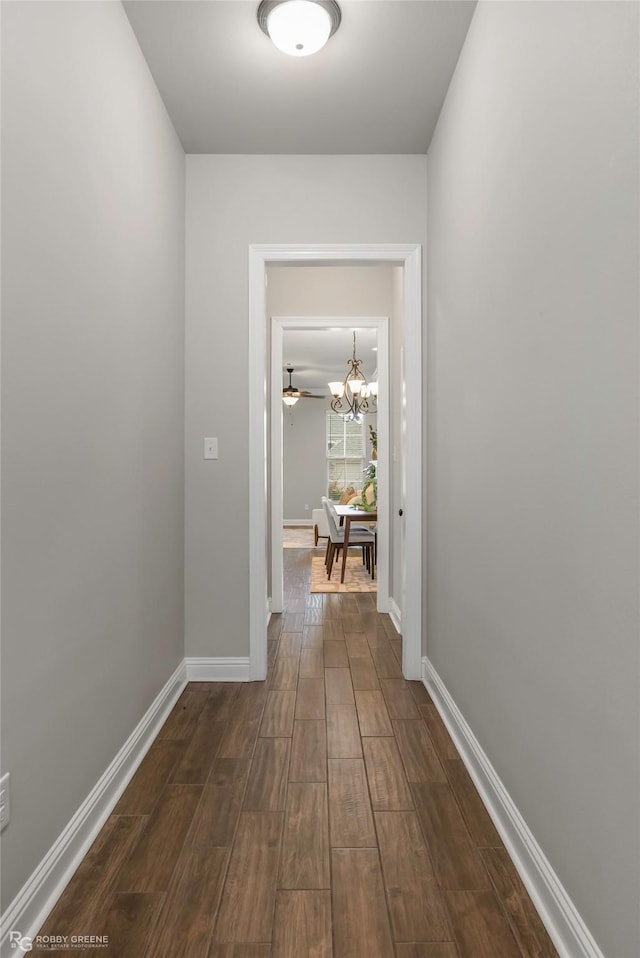 918 Hackberry Dr, Bossier City, LA 71111 - hallway with dark wood finished floors, a chandelier, and baseboards
