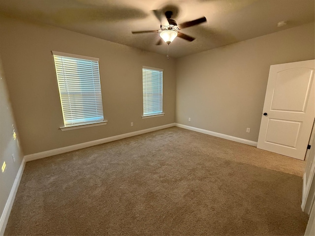 empty room featuring baseboards, carpet, and ceiling fan