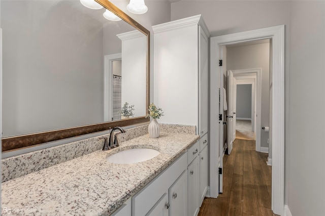 918 Hackberry Dr, Bossier City, LA 71111 - bathroom with vanity, wood finished floors, and baseboards