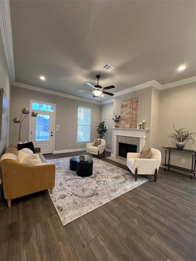 living room with a fireplace with flush hearth, dark wood finished floors, baseboards, and visible vents