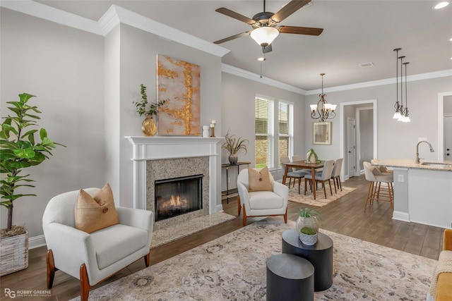 918 Hackberry Dr, Bossier City, LA 71111 - living room with a chandelier, dark wood-style flooring, baseboards, a high end fireplace, and crown molding