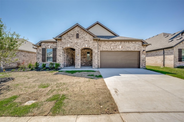 406 Eaton Dr, Justin, TX 76247 - french country inspired facade featuring brick siding, driveway, roof with shingles, and a garage
