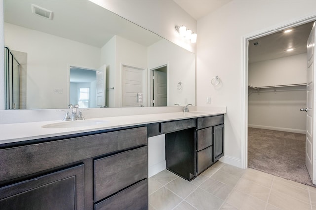 406 Eaton Dr, Justin, TX 76247 - full bathroom with a walk in closet, visible vents, a sink, and double vanity